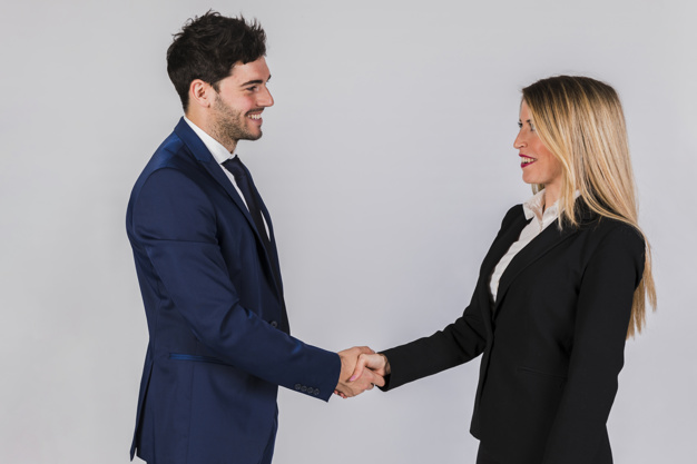 young-businessman-businesswoman-shaking-each-other-s-hand-against-grey-backdrop_23-2148119717